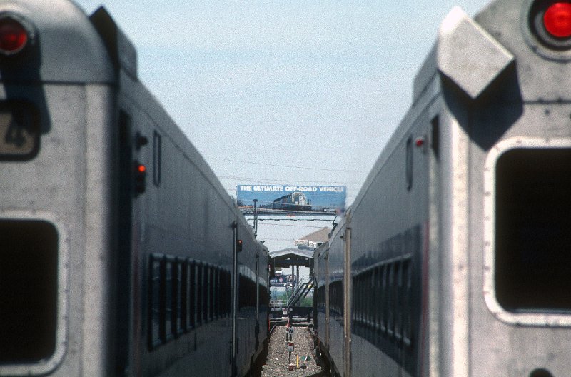 19890453-njt.jpg - May 22, 1999: Looking northwest from the station building between trains on tracks 2 and 3. The Intracoastal Waterway bridge is open for bridge traffic, and an NJT billboard attempts to entice drivers from the adjacent Atlantic City Expressway.