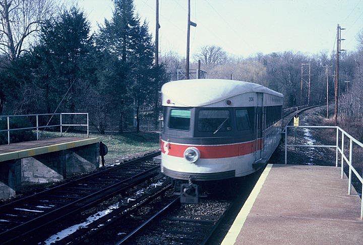 fp2.jpg - Wearing SEPTA's white/red/blue colors, bullet car 206 departs West Overbrook station for Norristown.