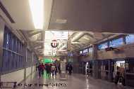 Upper level boarding area at Station C; passengers board train headed to Terminal area on the right