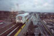 Train from Station A (Howard Beach), approaches Station C on the split level; tracks to Jamaica run straight ahead