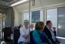 Group enjoys Portland sights aboard MAX light rail train.