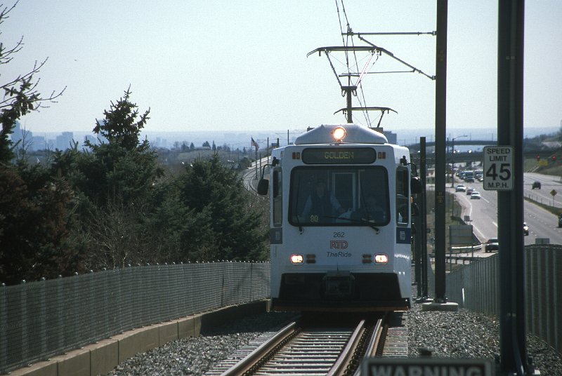 20130160-rtd.jpg - Train Carrying VIPs to the opening ceremony approaches the Johnson Road grade crossing, just east of the  Jefferson County Government Center-Golden Station. The train is made up of three SD-160s wrapped for the W-Line opening (262-261-264) (4/26/13)