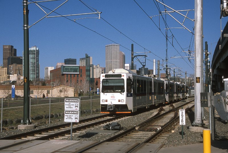 20130193-rtd.jpg - A C-Line train to Union Station approaches 5th Street on the relocated Central Platte Valley (CPV) trackage.  Before rebuilding in conjunction with the W-Line, the CPV trains would have passed through this area in the background near the blue sign at the left. (4/26/13) 