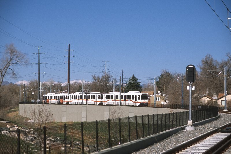 20130201-rtd.jpg - A train of SD-100s approaches Perry Station.  One of several late-season snows had hit Denver just three days before the W-Line opening, and the snow was still visible in the front range. (4/27/13)