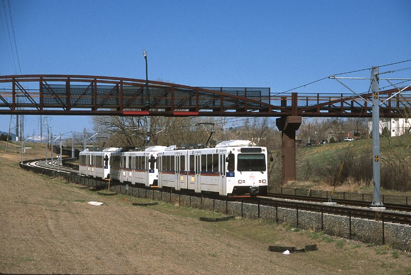 20130207-rtd.jpg - An eastbound W-Line train passes under a bridge at Tennyson Avenue that takes a bike path over the tracks; in the background another branch of the bike path crosses the tracks at grade. (4/27/13)