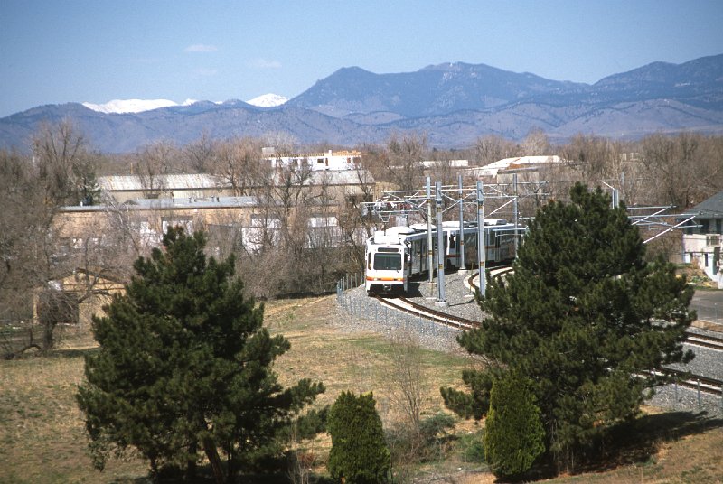 20130214-rtd.tif - West of Sheridan Station the line leaves the Dry Gulch alignment and begins to follow West 13th Avenue. An eastbound train approaches Sheridan Station. (4/27/13)