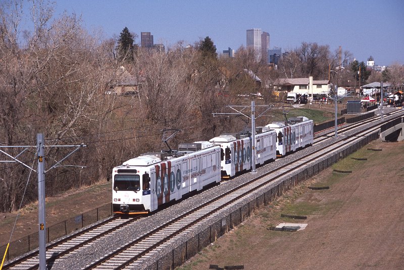 20130249-rtd.jpg - The "W-Line Train" heads westbound at the Tennyson Avenue overpass with the Denver skyline in the background. (4/27/13)